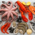 Taze balıklar, karidesler, ıstakoz, midye ve ahtapotun buz üzerinde özenle sergilendiği, deniz ürünlerinin zengin çeşitliliğini gözler önüne seren etkileyici bir sofra düzeni.